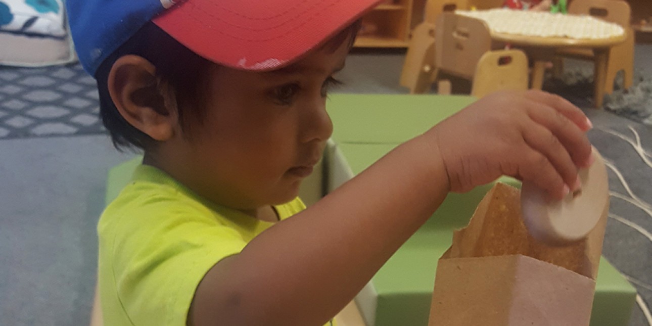 PIC young toddler interacting with paper bag