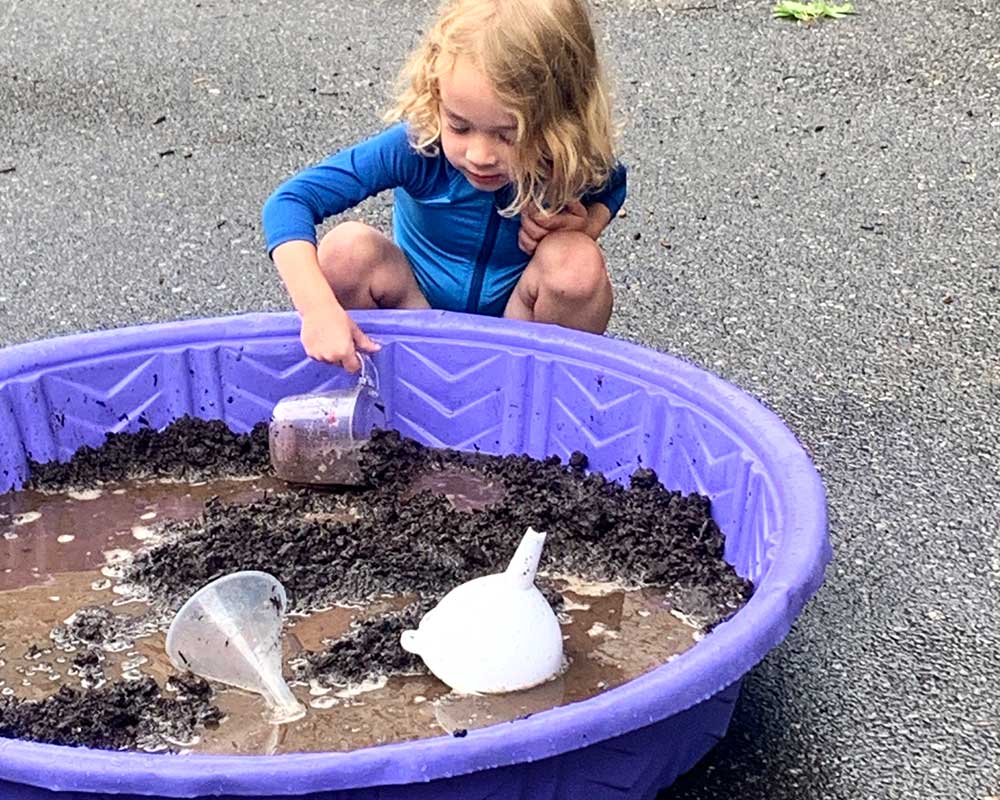 Mud Day 2025 - Scooping in muddy pool.