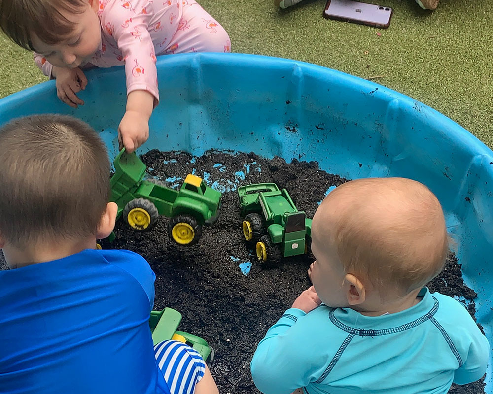 Mud Day 2025 - Babies in muddy pool.