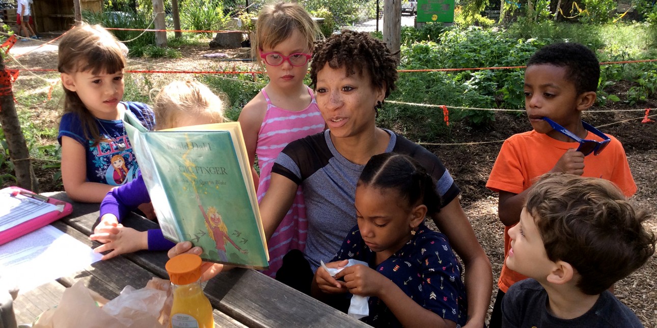School-agers share a story on the Nature Playground