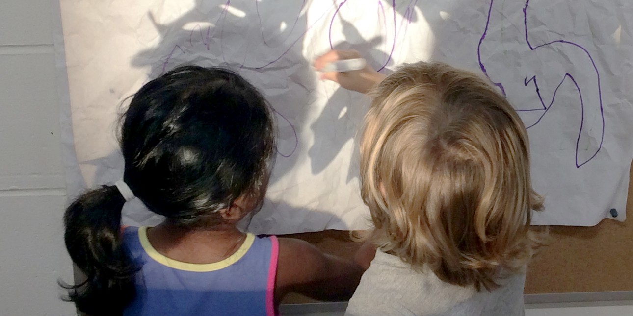 Preschoolers working with light and shadows