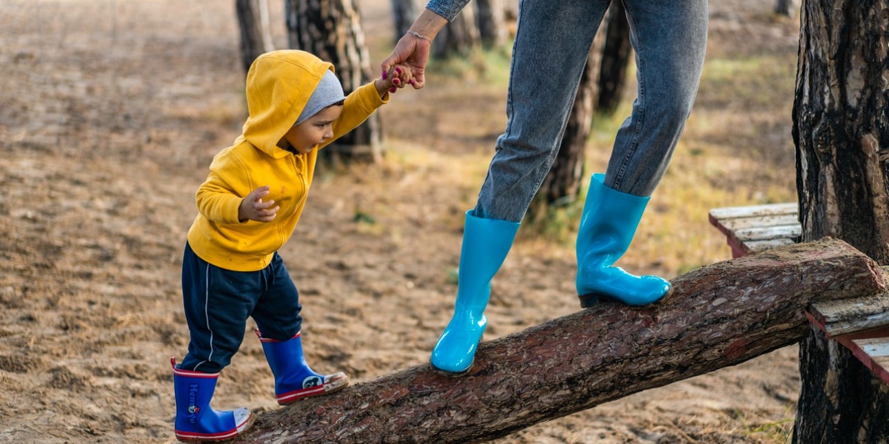 Lending a helping had to child on the nature playground