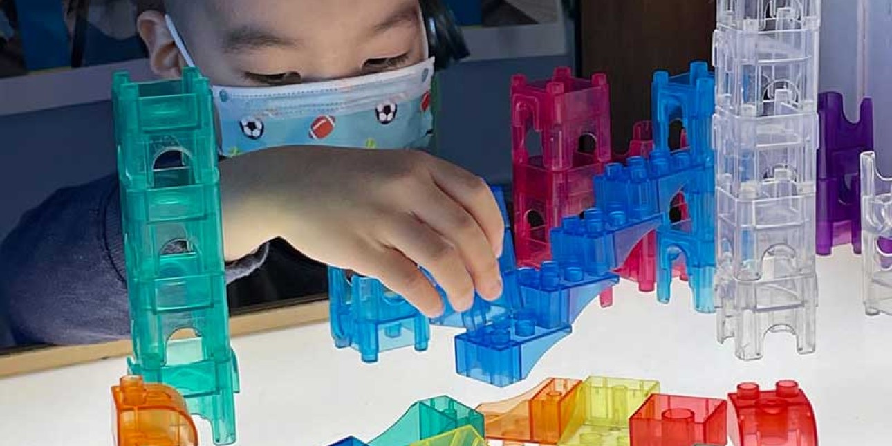 Preschooler learning at the light table through play