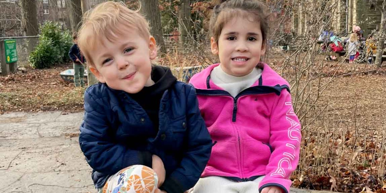 Two preschoolers on a stump