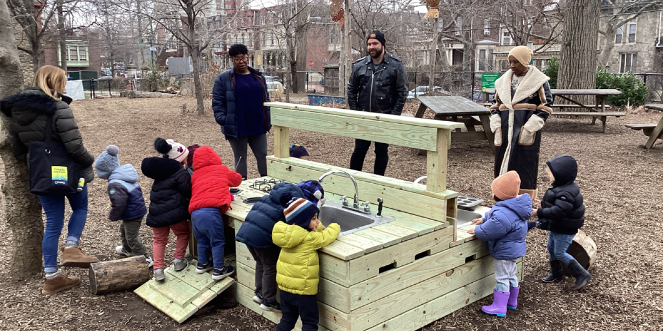 Toddlers in the mud kitchen