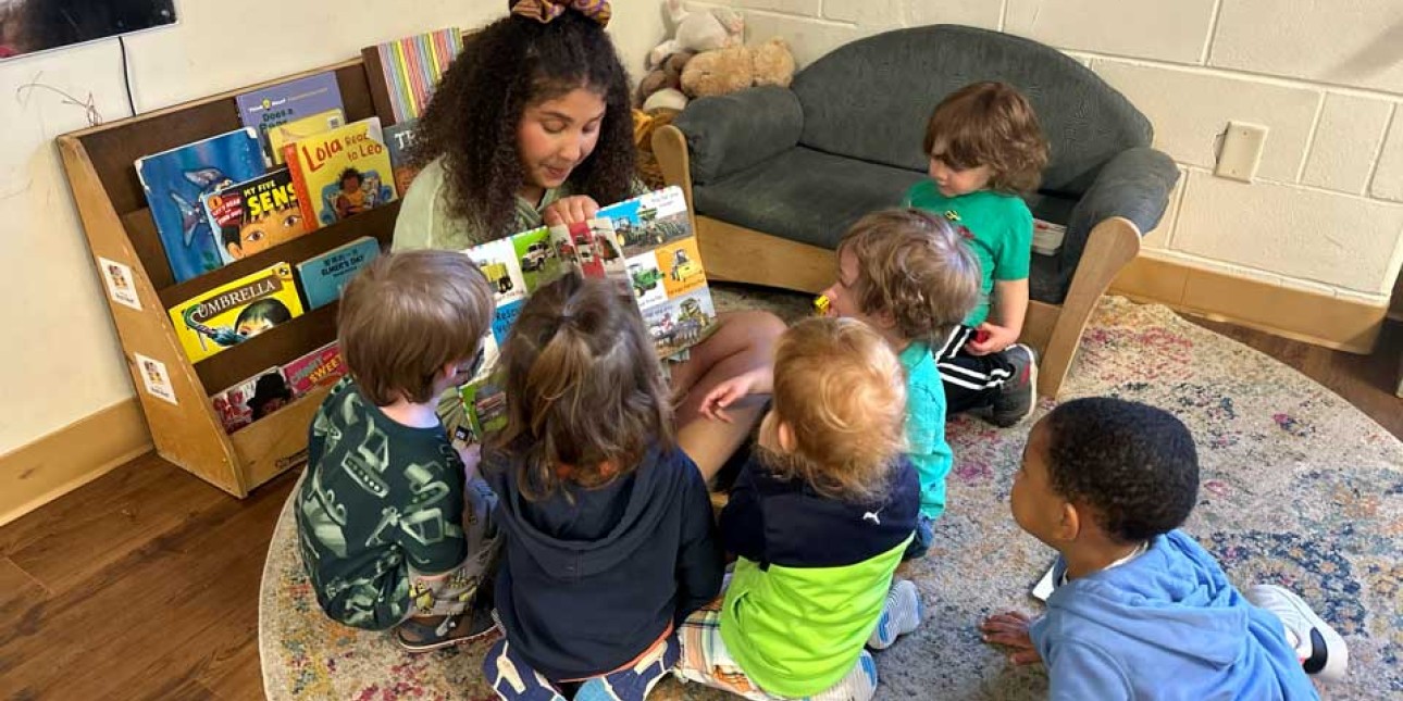 Teacher reads to a group of toddlers