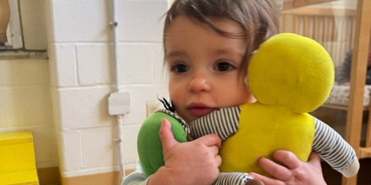 Young toddler with dolls