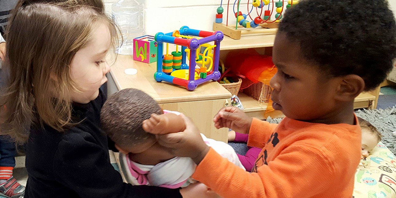 Toddlers negotiating possession of a doll