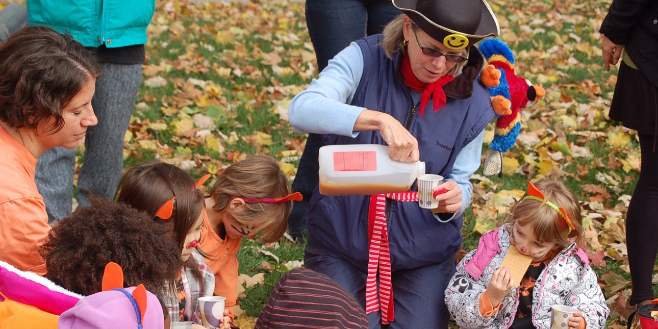 Cindy Roberts serves cider to preschoolers at PIC