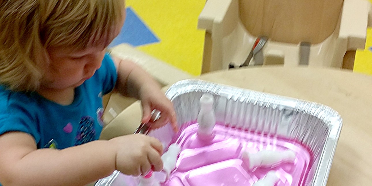 PIC young toddler explores water