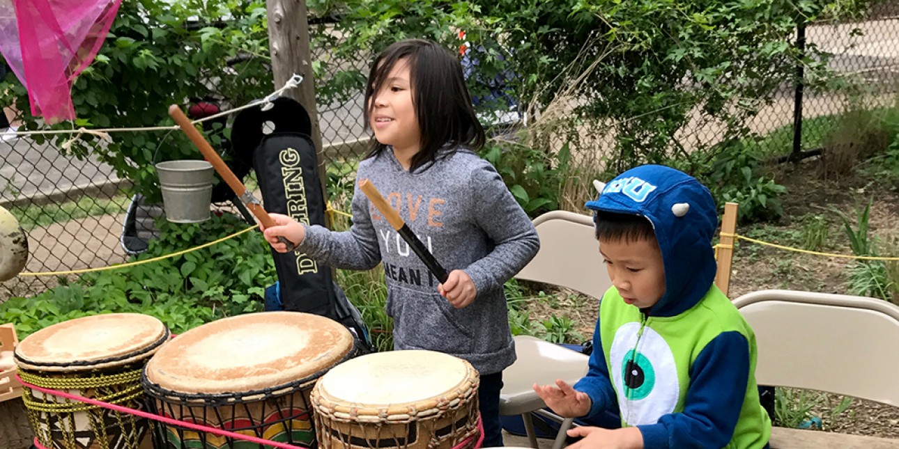 Children drumming at PIC's first Day of Play