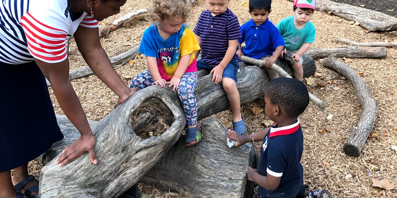 PIC teacher and toddlers on the nature playground