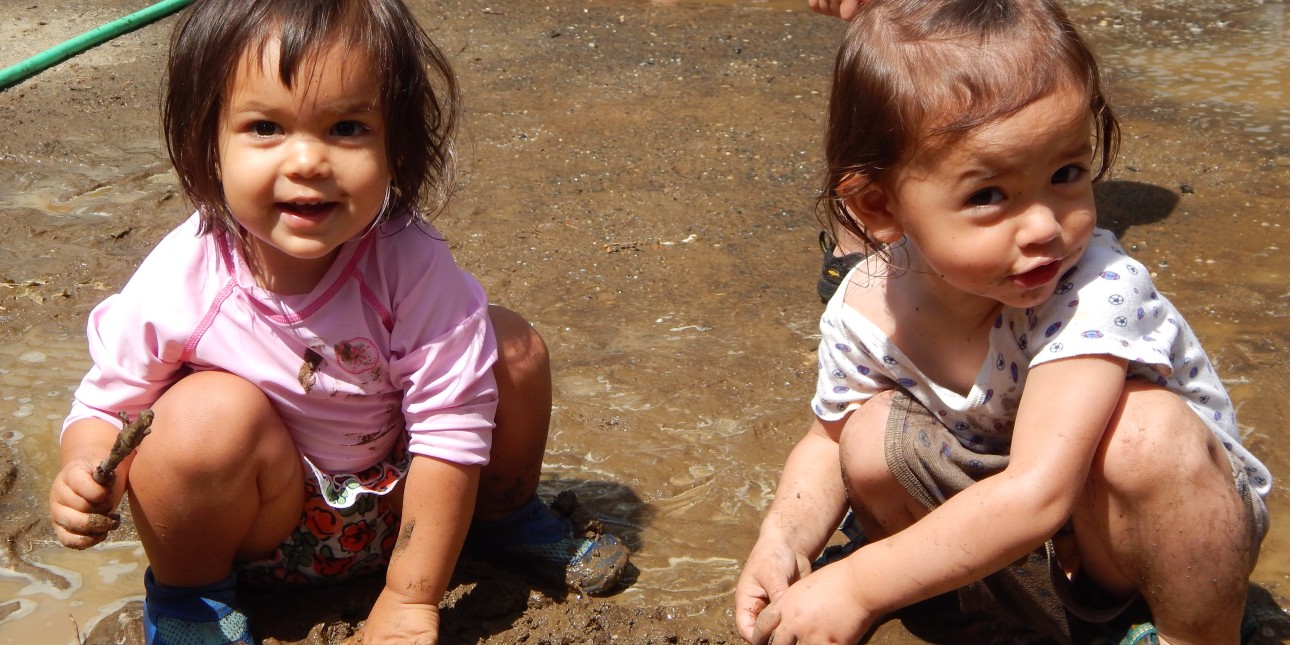Toddlers play in mud