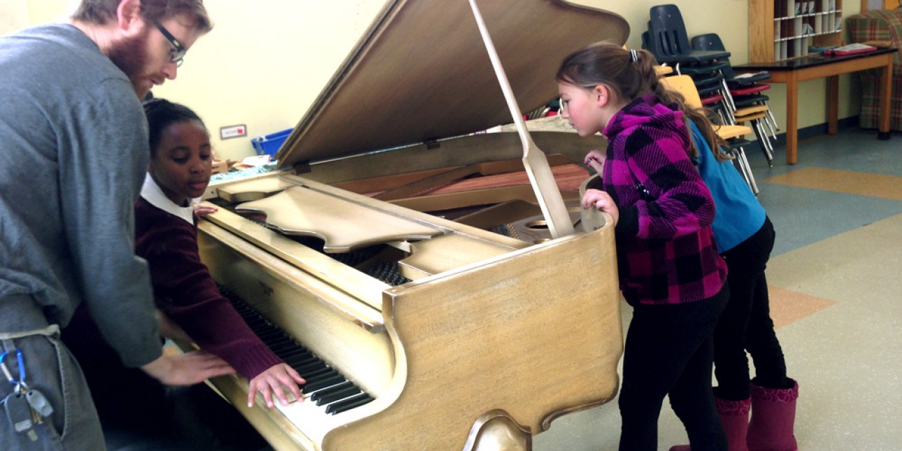 PIC teacher John Schaaf and after schoolers at new piano