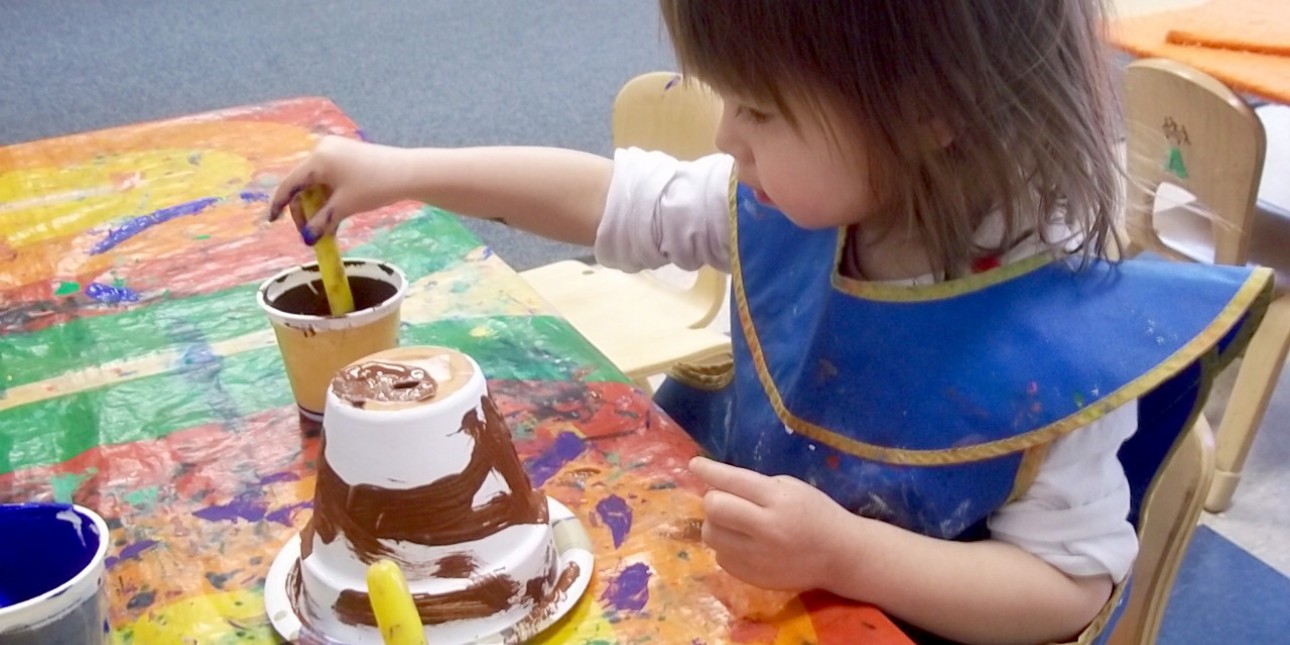 Toddler painting KidPots for PIC Plant Sale