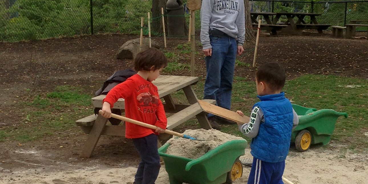 Spreading sand on the playground at PIC