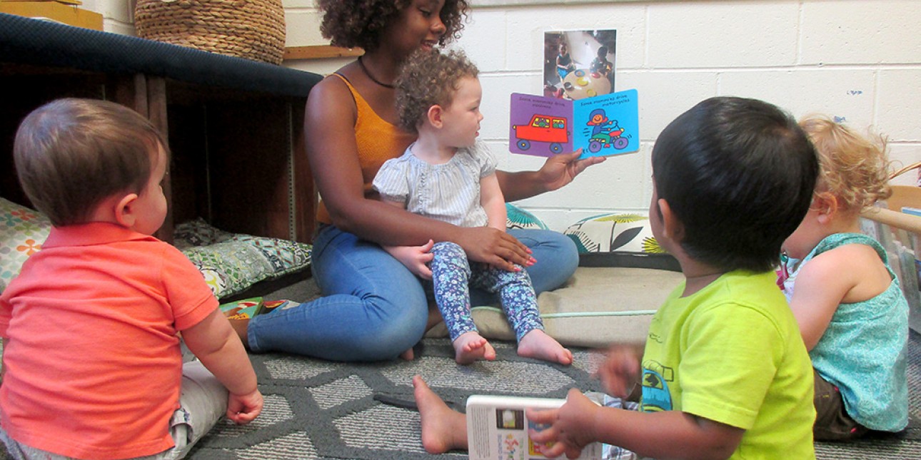 PIC Teacher reading to young toddlers.